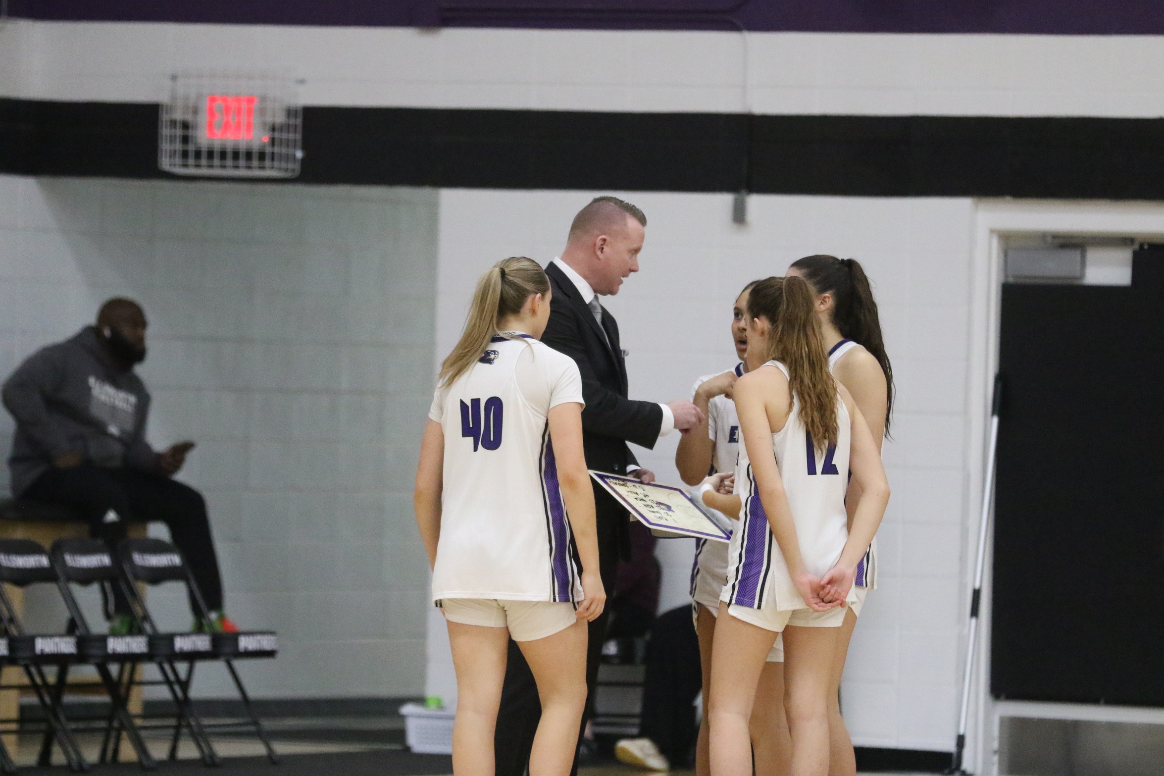 Coach Justin Rees chats with his team, photo by Marissa VanWingen of The Times Citizen. 